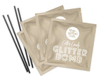 Close up of the four packages of Cotton Candy Gold Glitter Bomb and stir straws provided. 