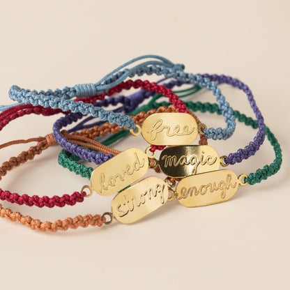 Colorful bracelets with gold tags on a white background