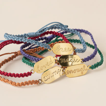 Colorful bracelets with gold tags on a white background