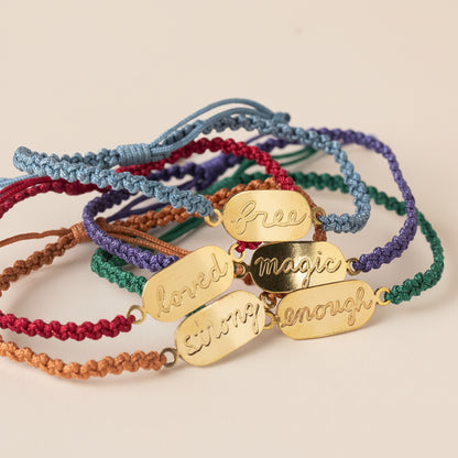 Colorful bracelets with gold tags on a white background