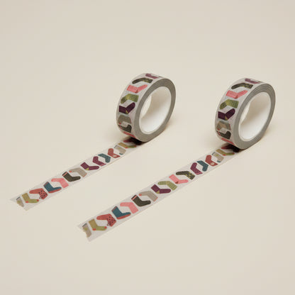 Two rolls of decorative sock or stocking  washi tape with colorful patterns, on a white background