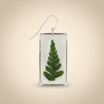 Earring with a pressed green leaf in a silver frame on a white background