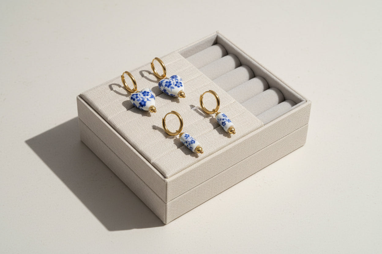 Set of four floral-themed earrings on a white background
