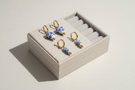 Set of four floral-themed earrings on a white background