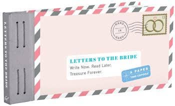 Close up view of the “Letters to the Bride” book with blush pink envelopes and vintage-style stickers