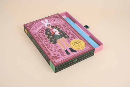 Fashion doll packaging with a pink and green design on a white background