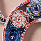 Colorful woven pattern on a wooden surface