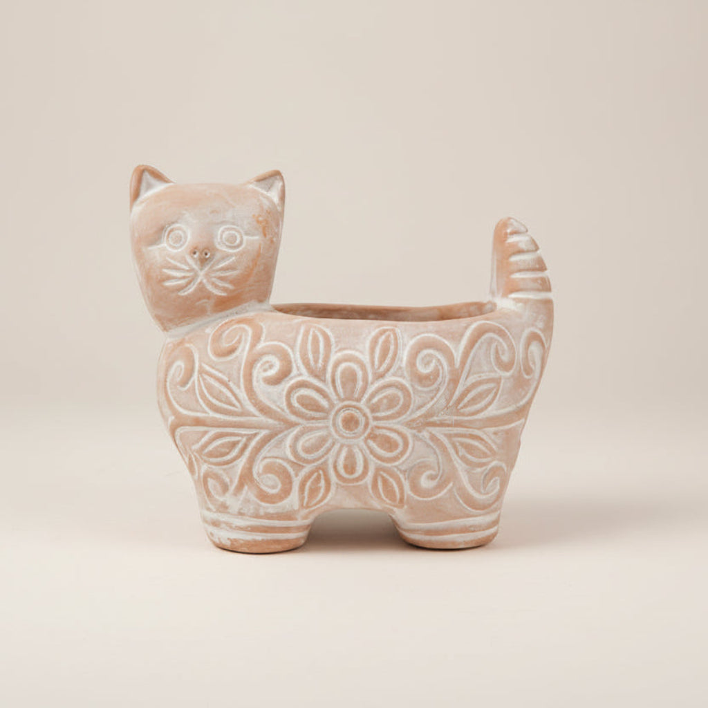 Cat-shaped ceramic planter with floral patterns on a white background