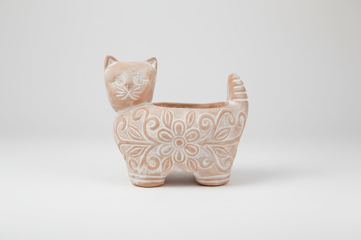 Cat-shaped ceramic planter with floral patterns on a white background