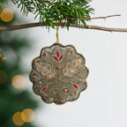 Decorative ornament with floral patterns hanging on a tree branch.