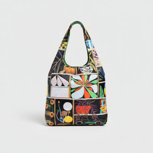 An eco-friendly tote bag designed by Paul Wackers, featuring bold, surreal artwork in an airbrush-meets-collage style.