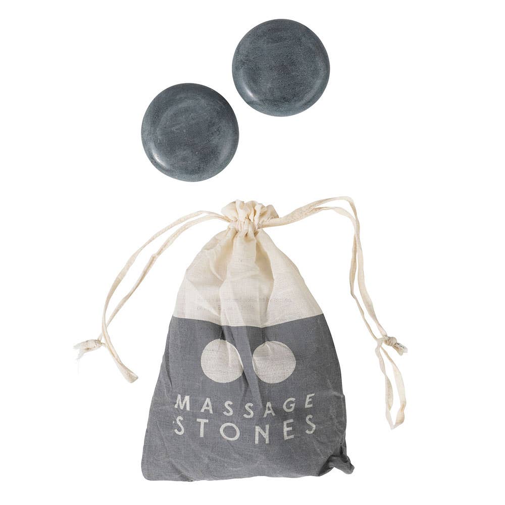 Two gray massage stones with a drawstring bag labeled 'Massage Stones' on a white background.