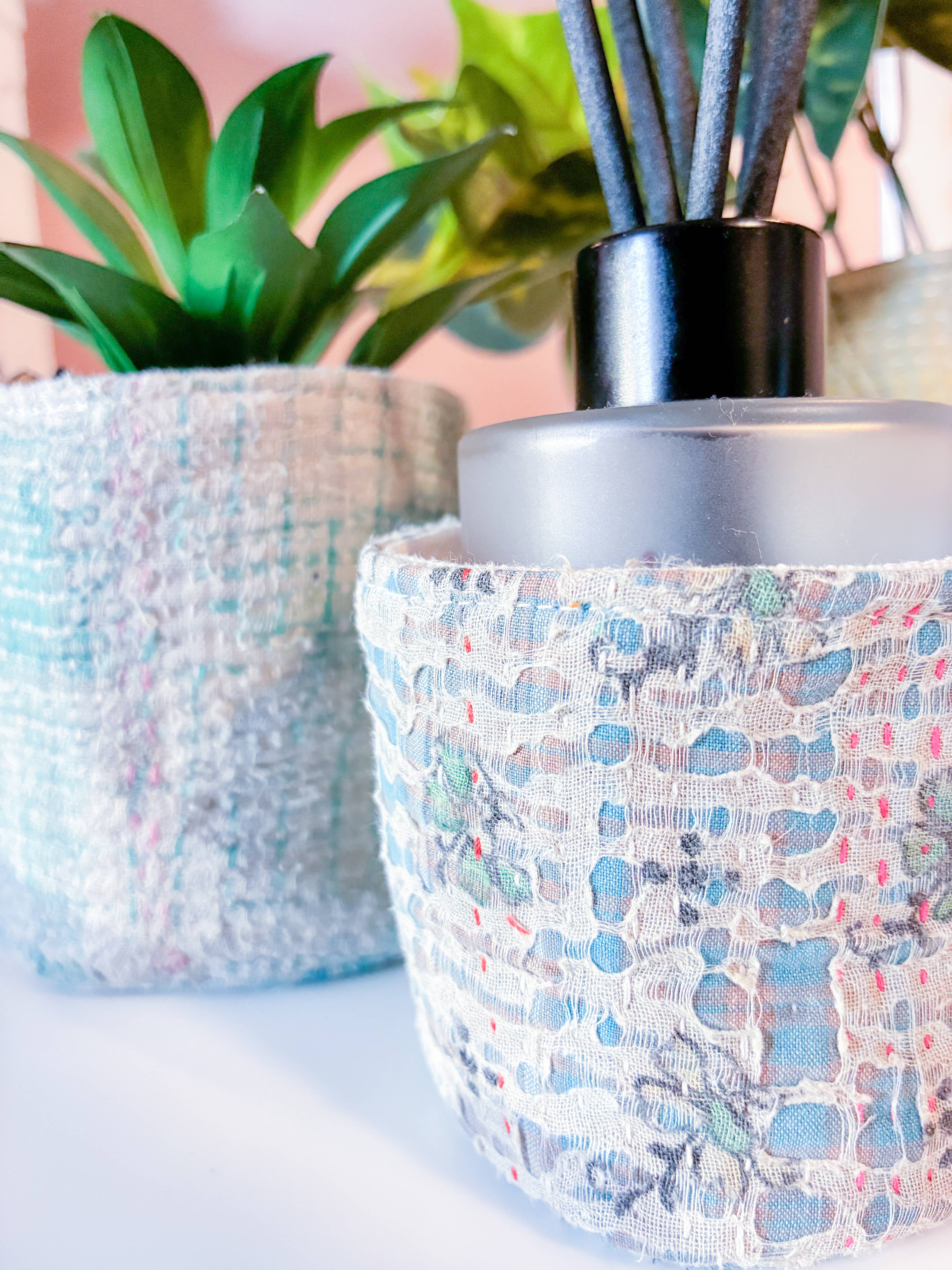 Decorative pot with diffuser and plants on a light background