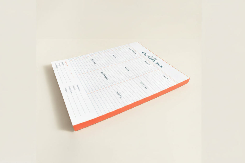 Notepad with a grocery list template on a white background