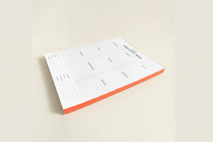 Notepad with a grocery list template on a white background