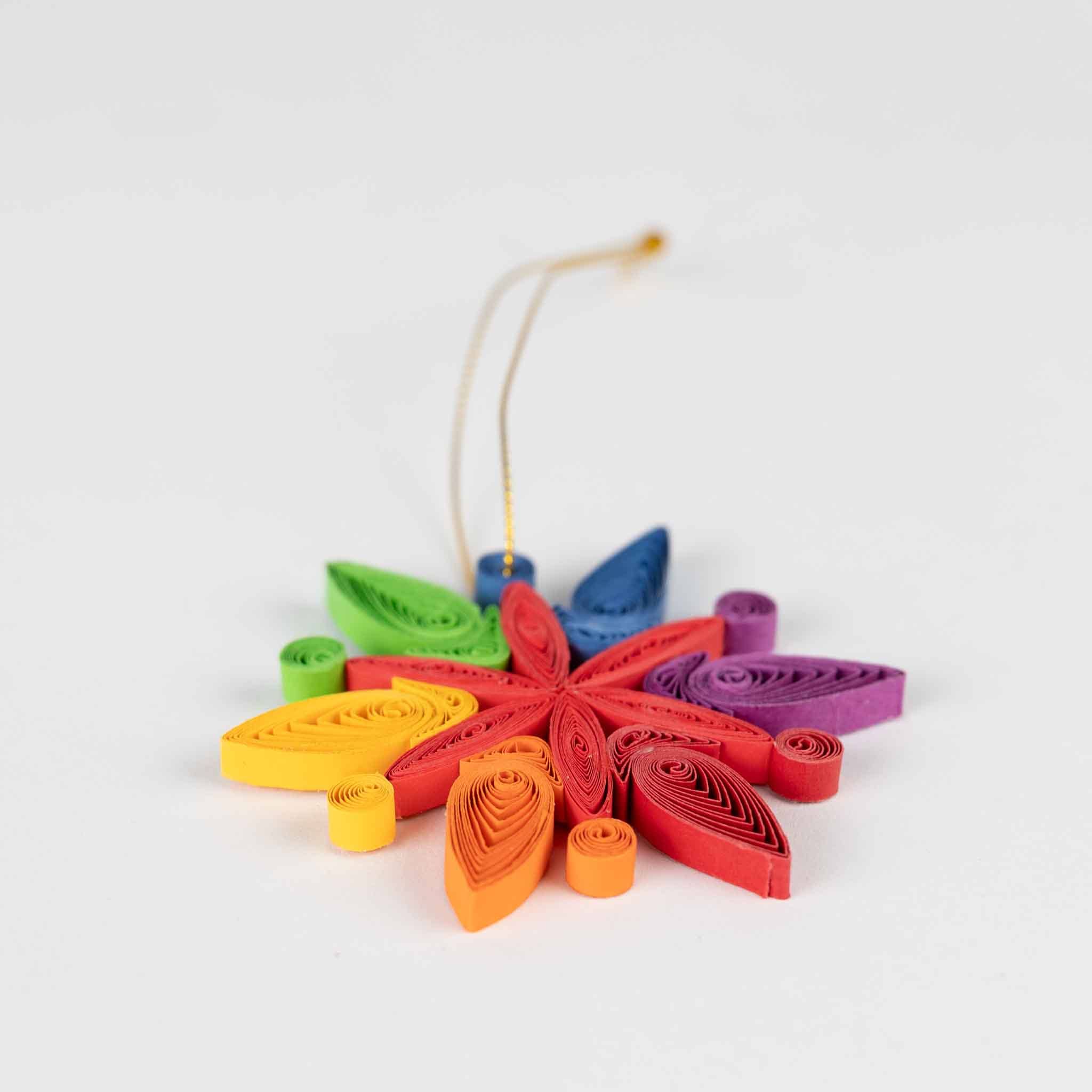 Colorful paper quilled flower ornament on a white background