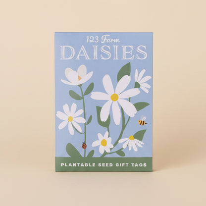 Pack of plantable seed gift tags with daisy design on a blue background