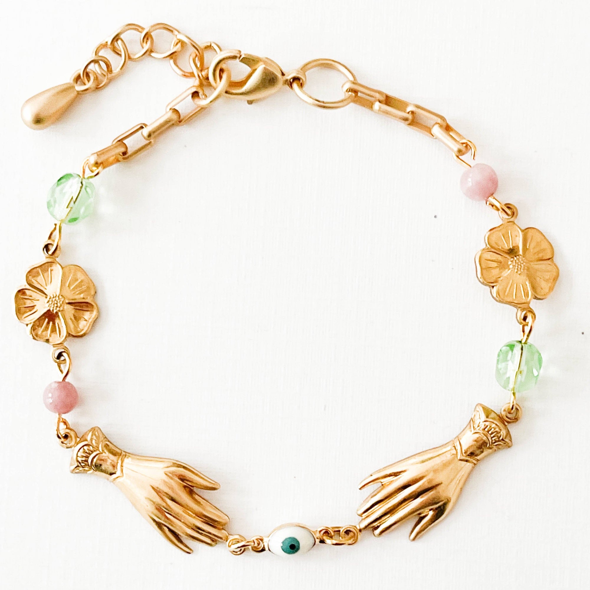 Handmade jewelry flat lay with springtime accessories and floral props