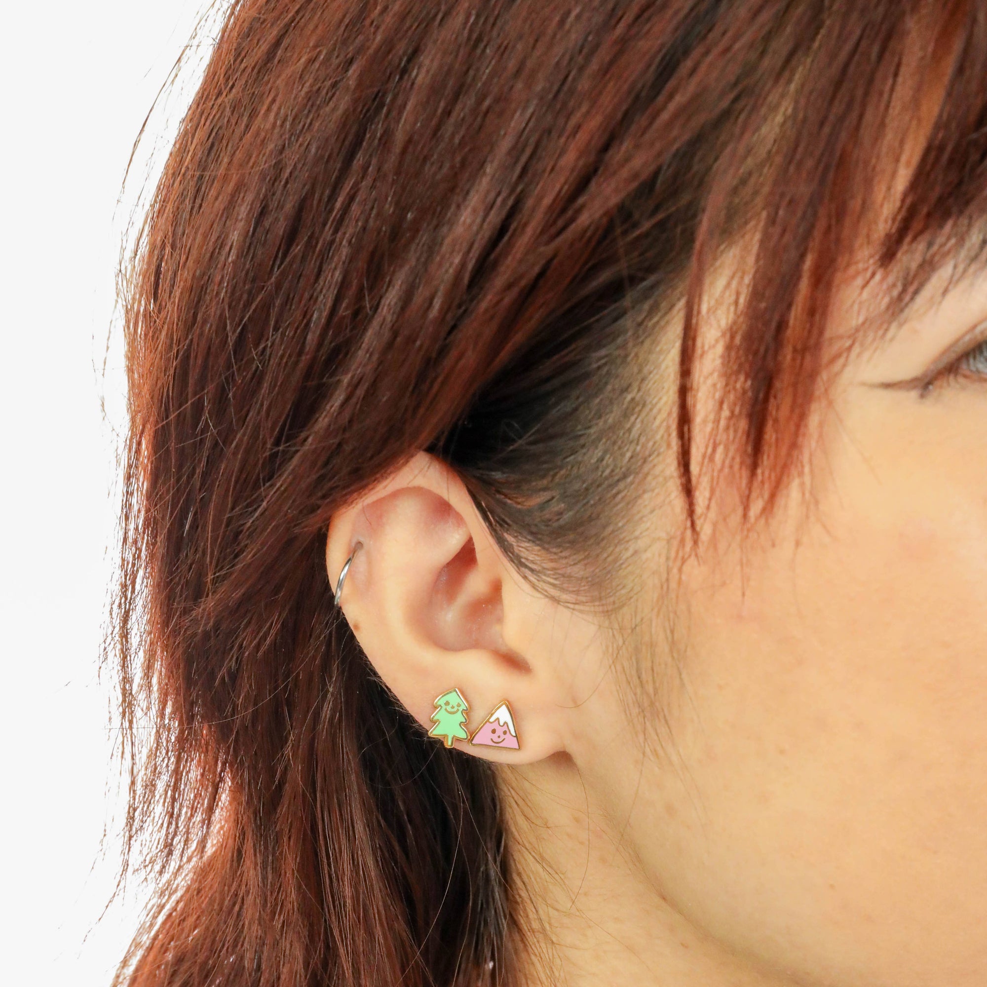 Picture of person wearing the Mountain & Tree Earrings - Gold Outdoorsy Nature Studs