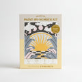 Celestial paint-by-number kit packaging with sun and moon design on a beige background