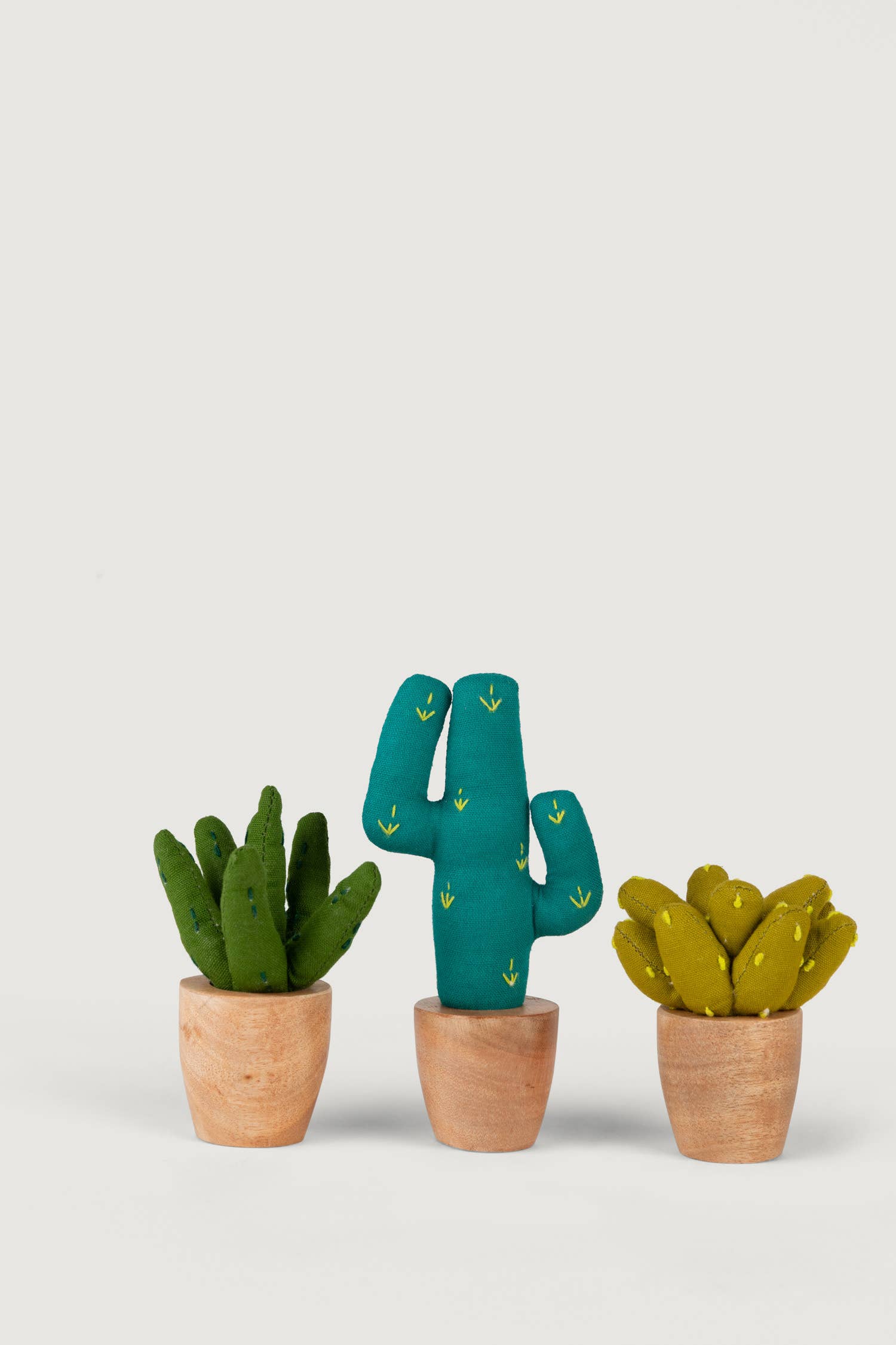 Trio of mini fabric plants including aloe, prickly pear, and saguaro