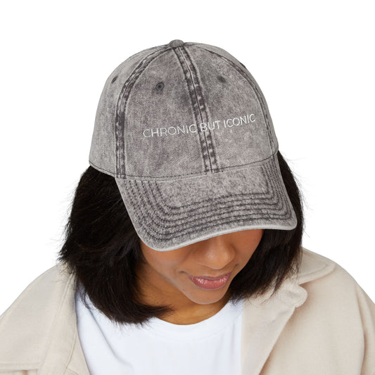 Person wearing a gray denim cap with 'Chronic But Iconic' text on a white background