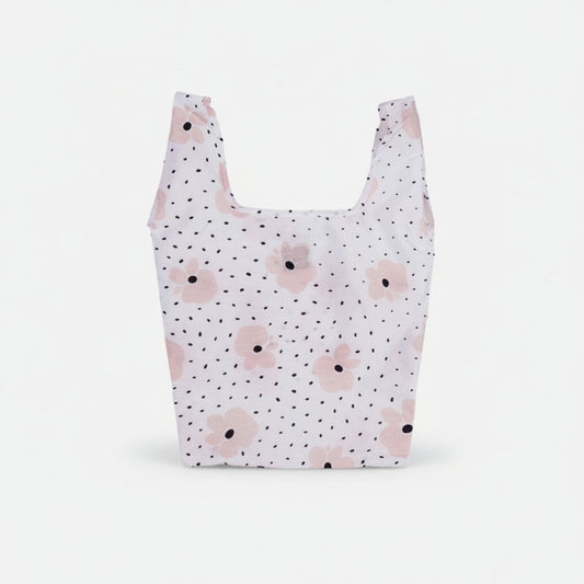 Compact tote bag with a blush pink floral pattern on a black speckled background.