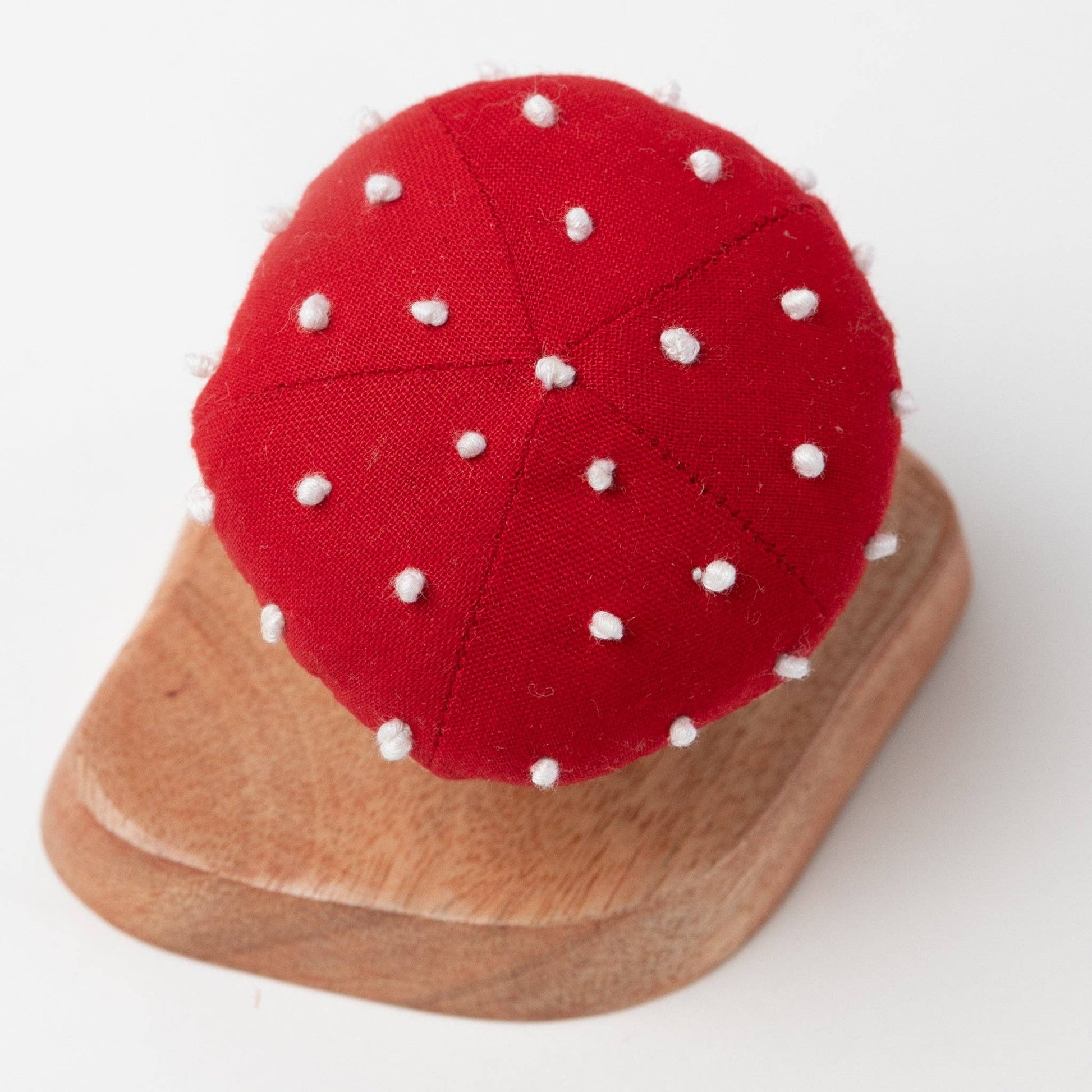 Overhead view of the red mushroom top with hand-stitched white spots for added details