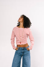 Side view of the necklace draped over a white ceramic jewelry stand to show how it hangs when worn