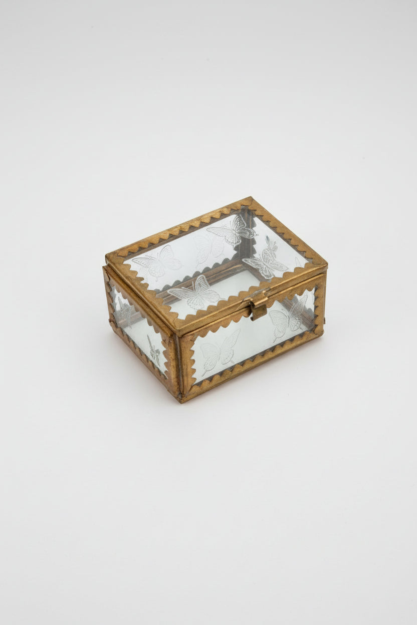 A small glass box with brass and etched stars