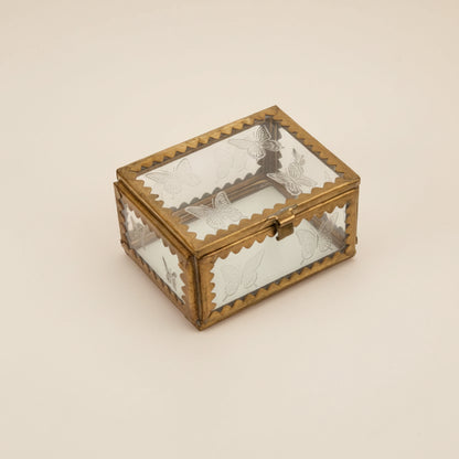 A small glass box with brass and etched stars