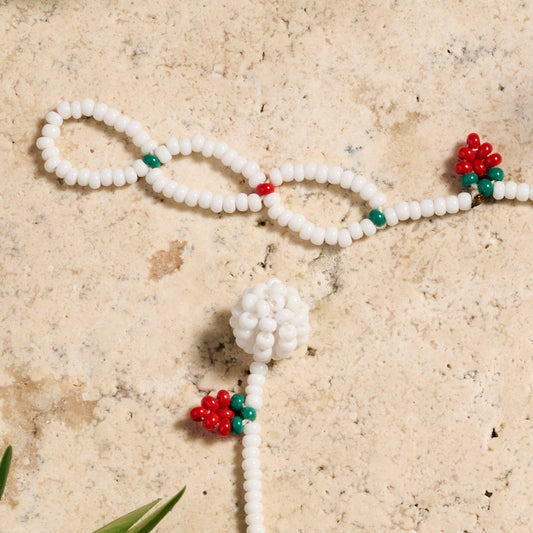 Hand-beaded Taja bracelet with strawberry motif on soft cotton thread, adjustable closure visible