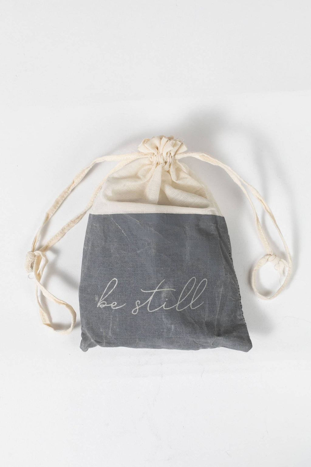 Drawstring bag with 'be still' text on a white background