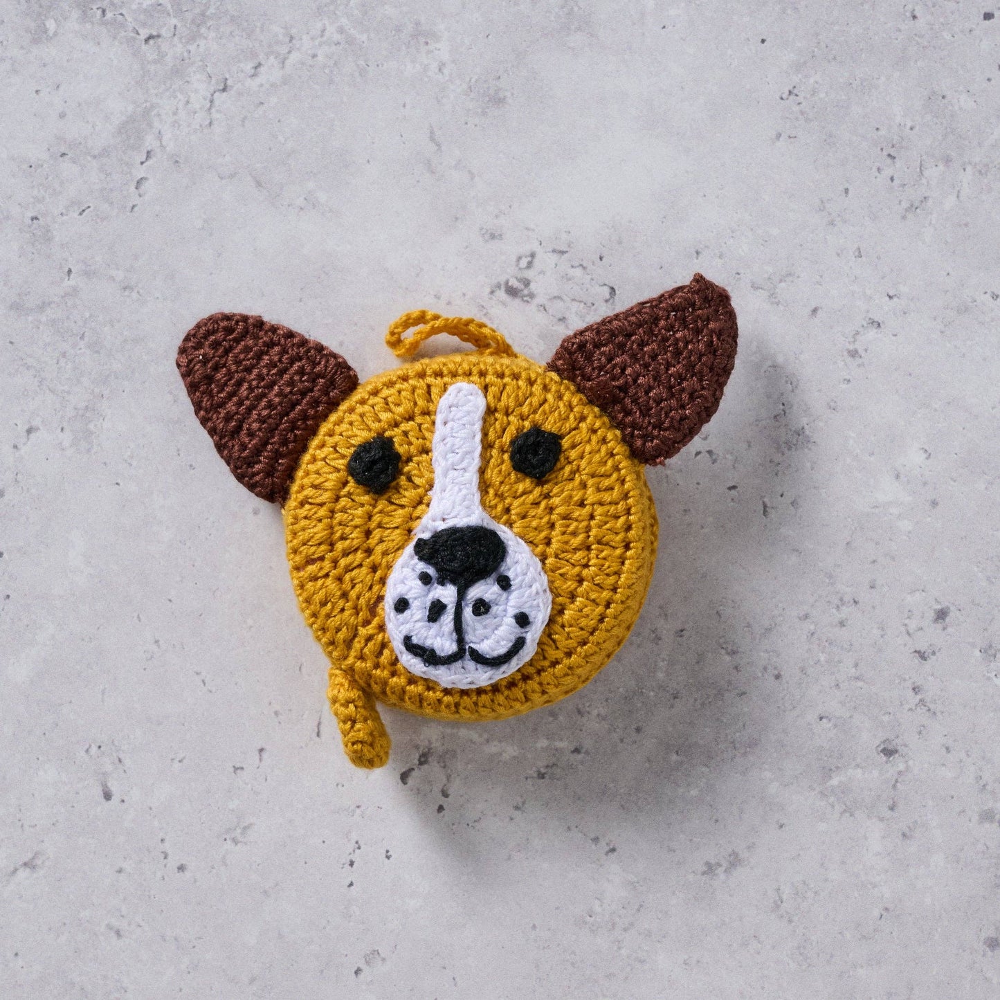 Close-up of soft crochet texture and color details in brown, golden, and white
