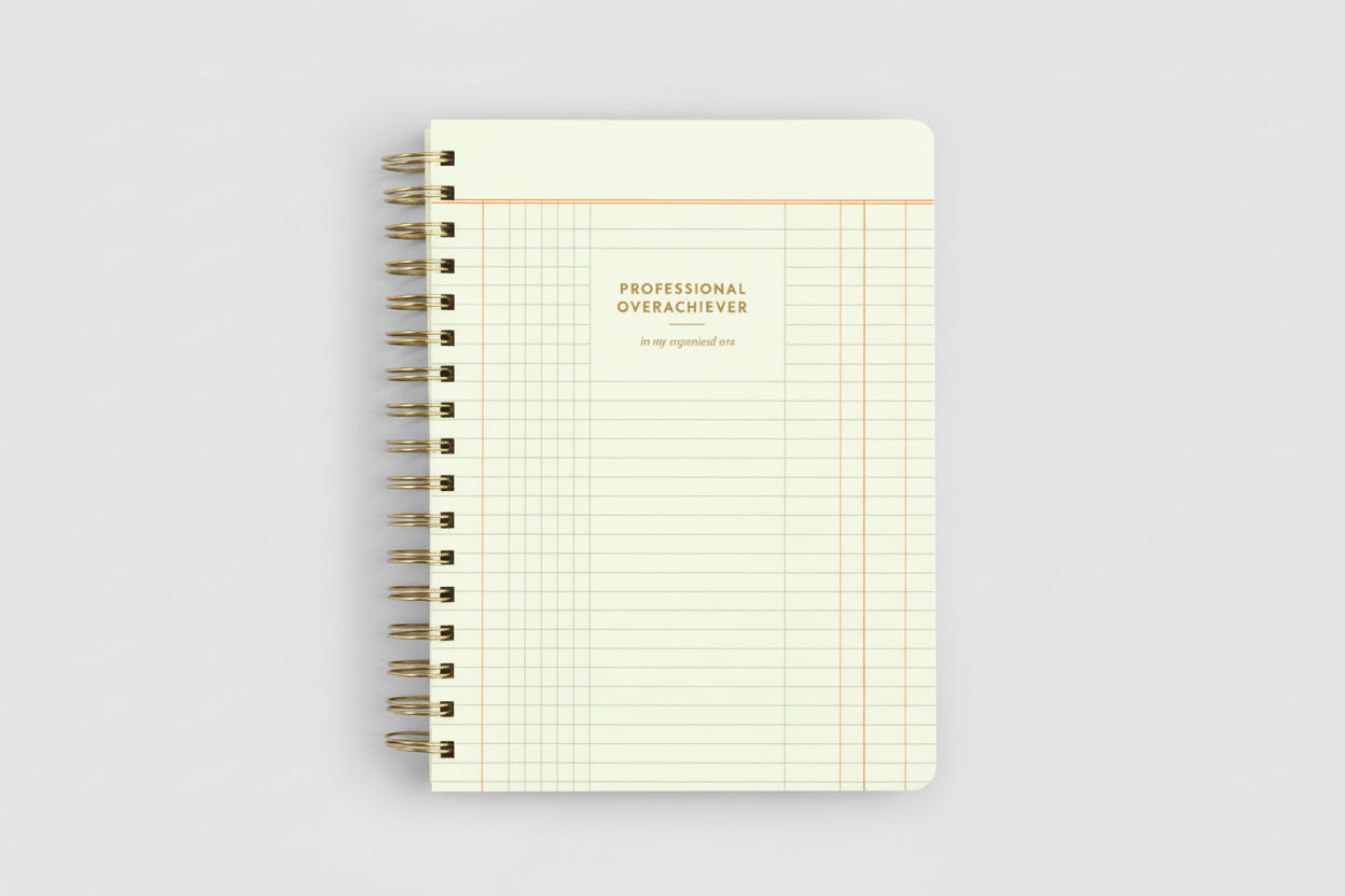 Notebook with grid pattern and 'Professional Overachiever' text on a white background