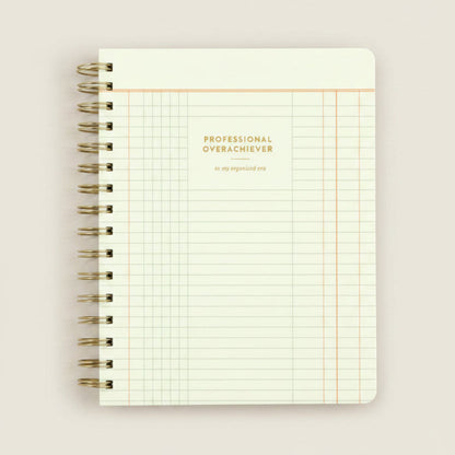 Notebook with grid pattern and 'Professional Overachiever' text on a white background