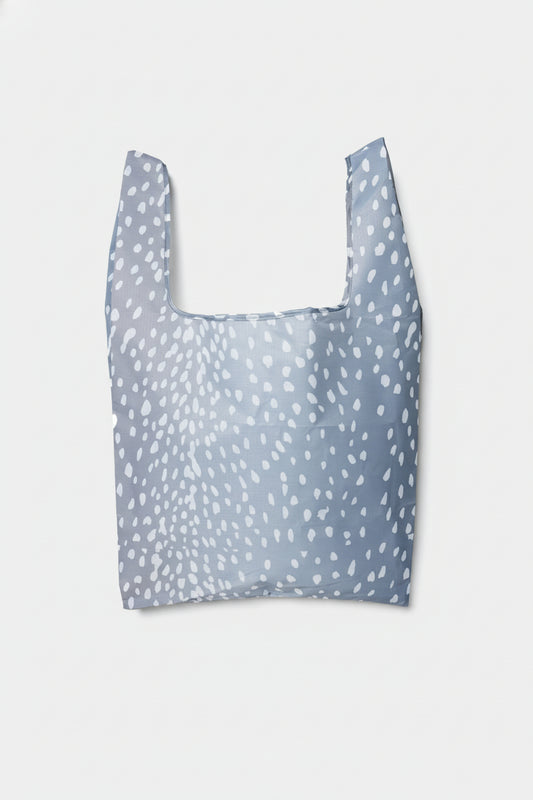 A blue tote shopping bag with a woodland-inspired fawn-print pattern.