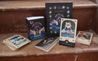 Collection of tarot cards and books on a wooden surface