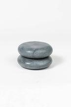 Two stacked gray stones on a white background