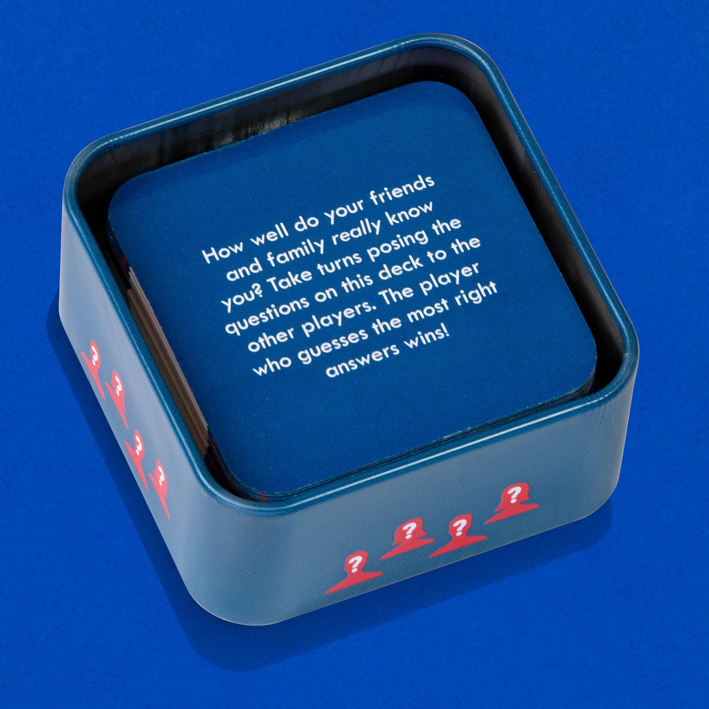 Blue card game box with text and question mark symbols on a blue background