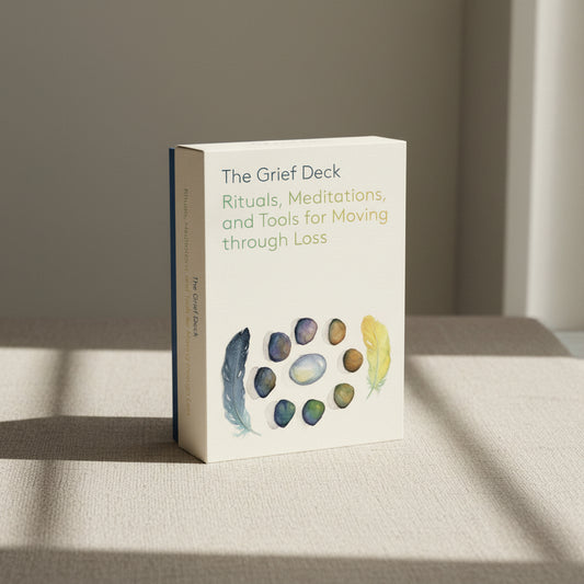 'The Grief Deck' box is decorated with  illustrations of stones and feathers on a beige background