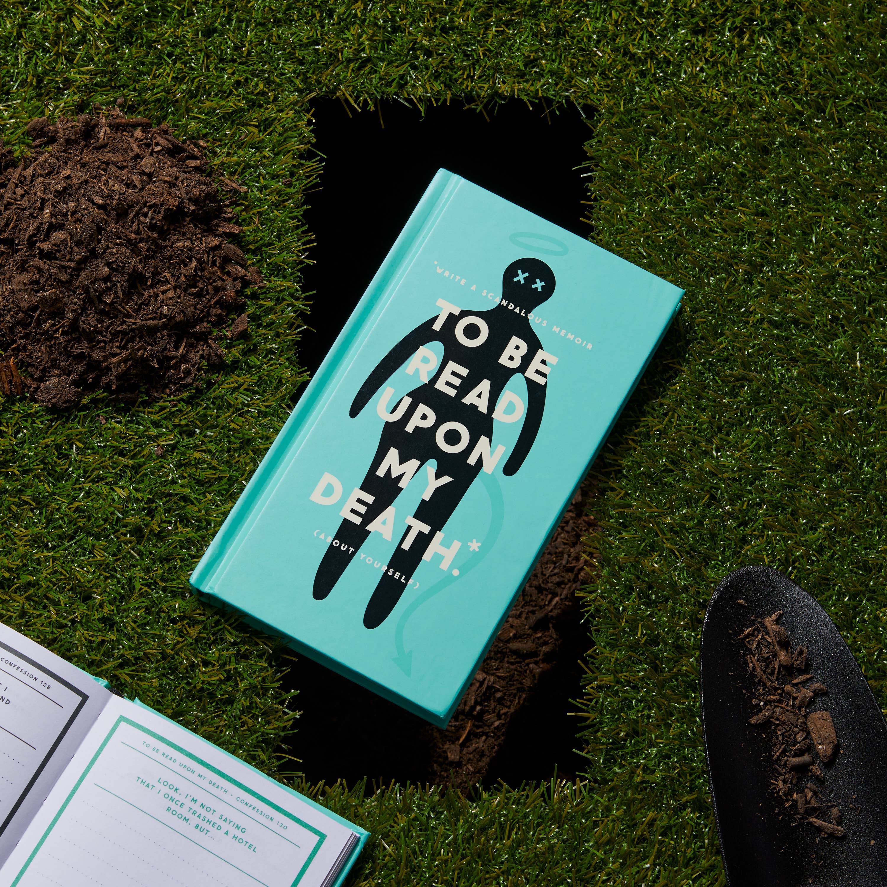 Flat lay featuring the journal alongside a gravesite illustration