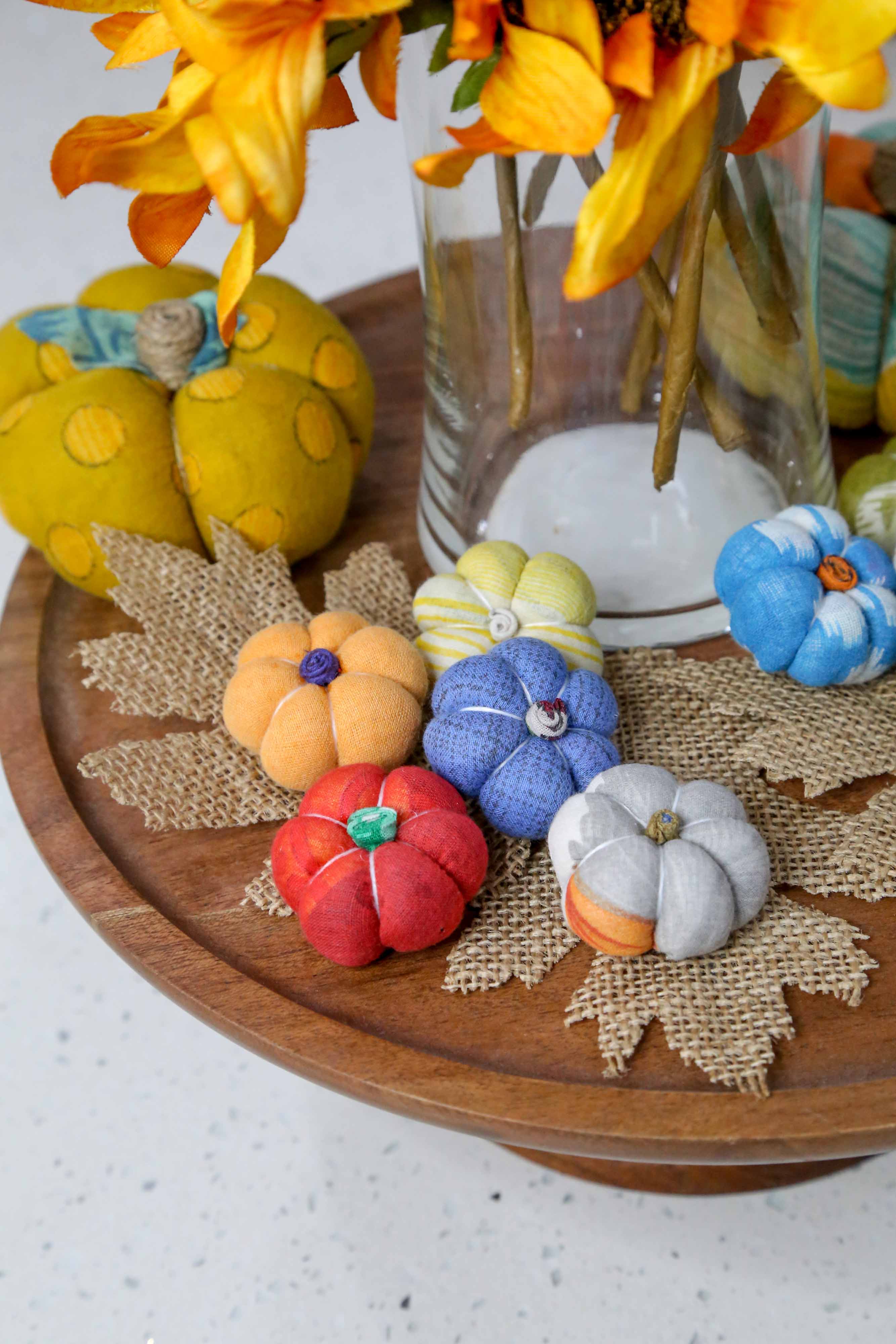 Mini pumpkins arranged in a rustic bowl as part of a fall centerpiece