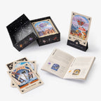 Set of tarot cards with a deck, box, and open book on a white background
