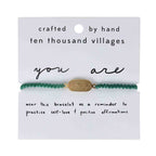 Adjustable green macrame bracelet with brass charm engraved "You Are Enough"