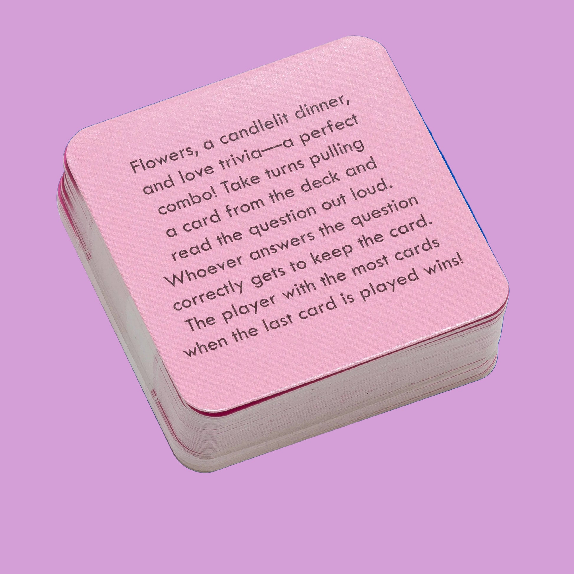 Pink card game box with text on a pink background