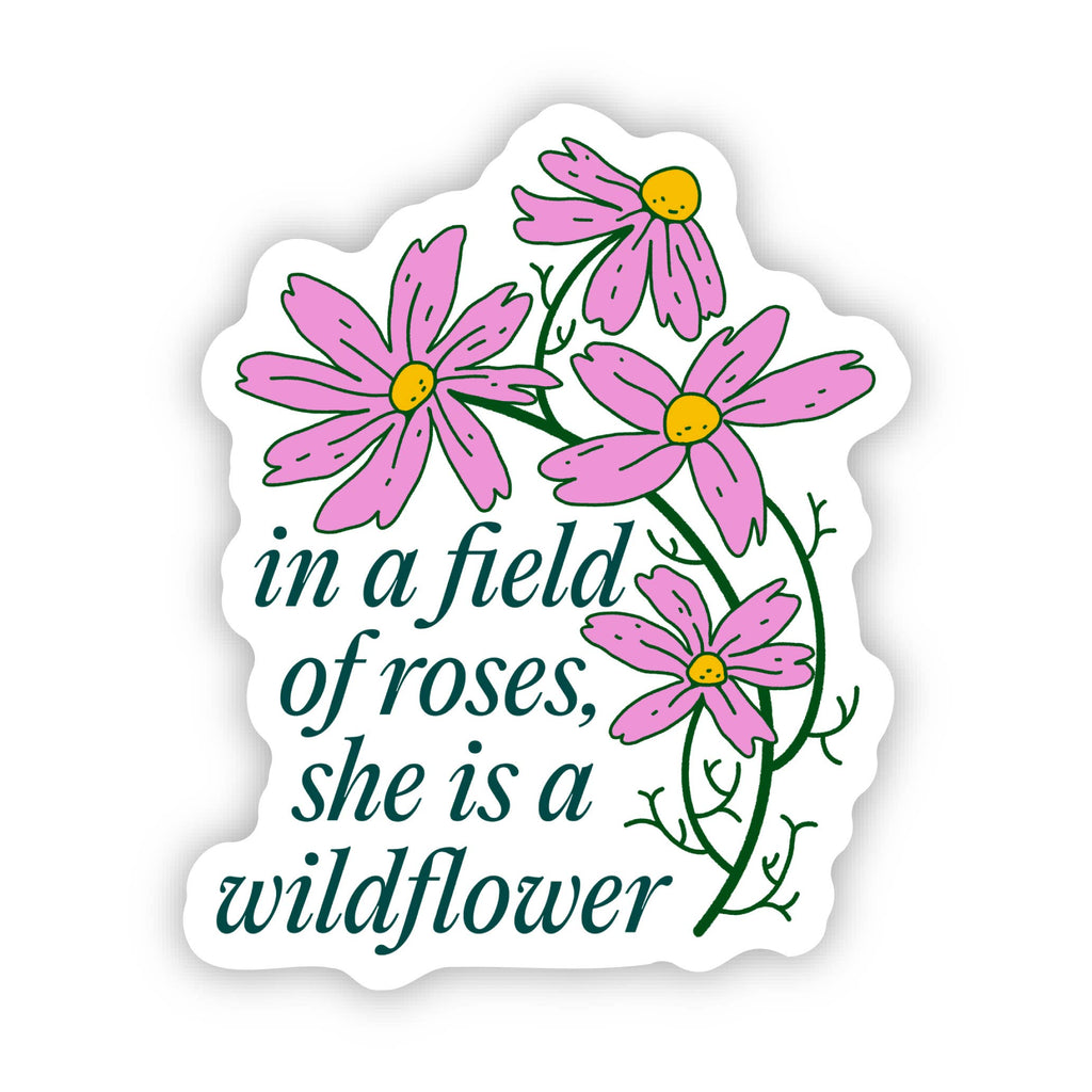 Sticker with pink flowers and text 'in a field of roses, she is a wildflower' on a white background