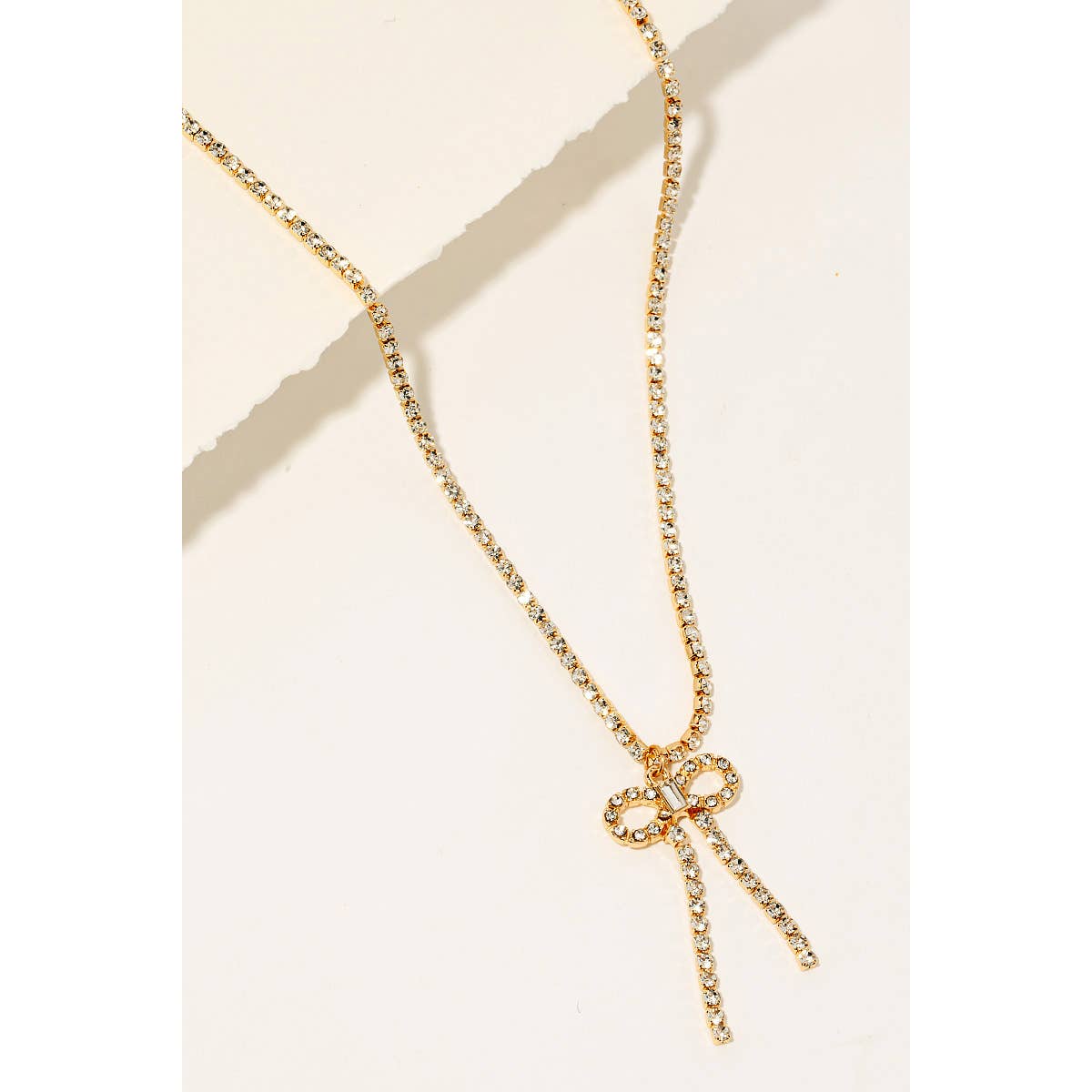 Rhinestone necklace with dainty ribbon bow pendant
