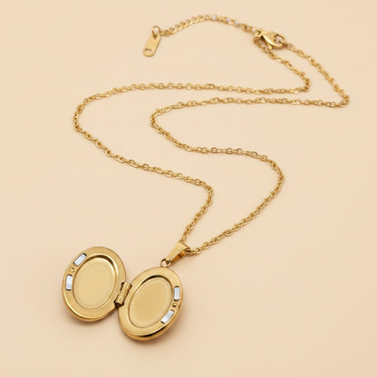 Gold locket necklace on a white background