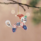 Decorative ornament shaped like a cat with colorful patterns hanging from a branch.